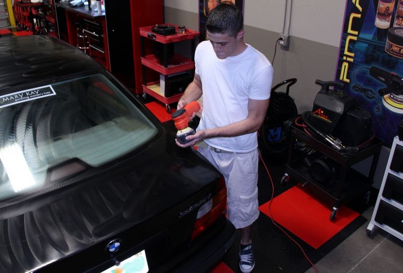 Machine applying wax to car.