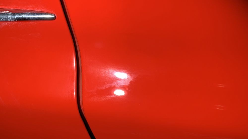 Coating high spot on red paint.