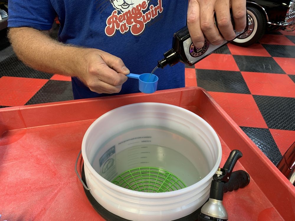 Mixing DP Ceramic Wash into bucket of water.