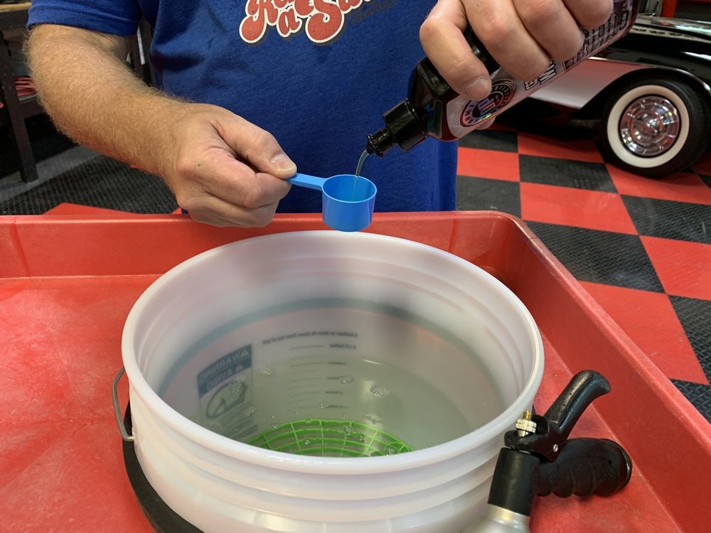 Mixing DP Ceramic Wash into bucket of water