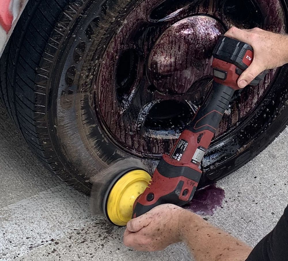 Machine scrubbing the tires while wheels soak.