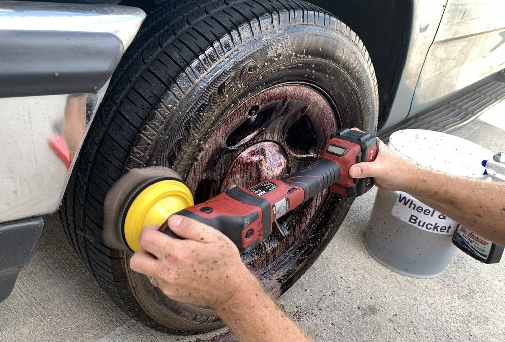 Machine scrubbing the tires while wheels soak.